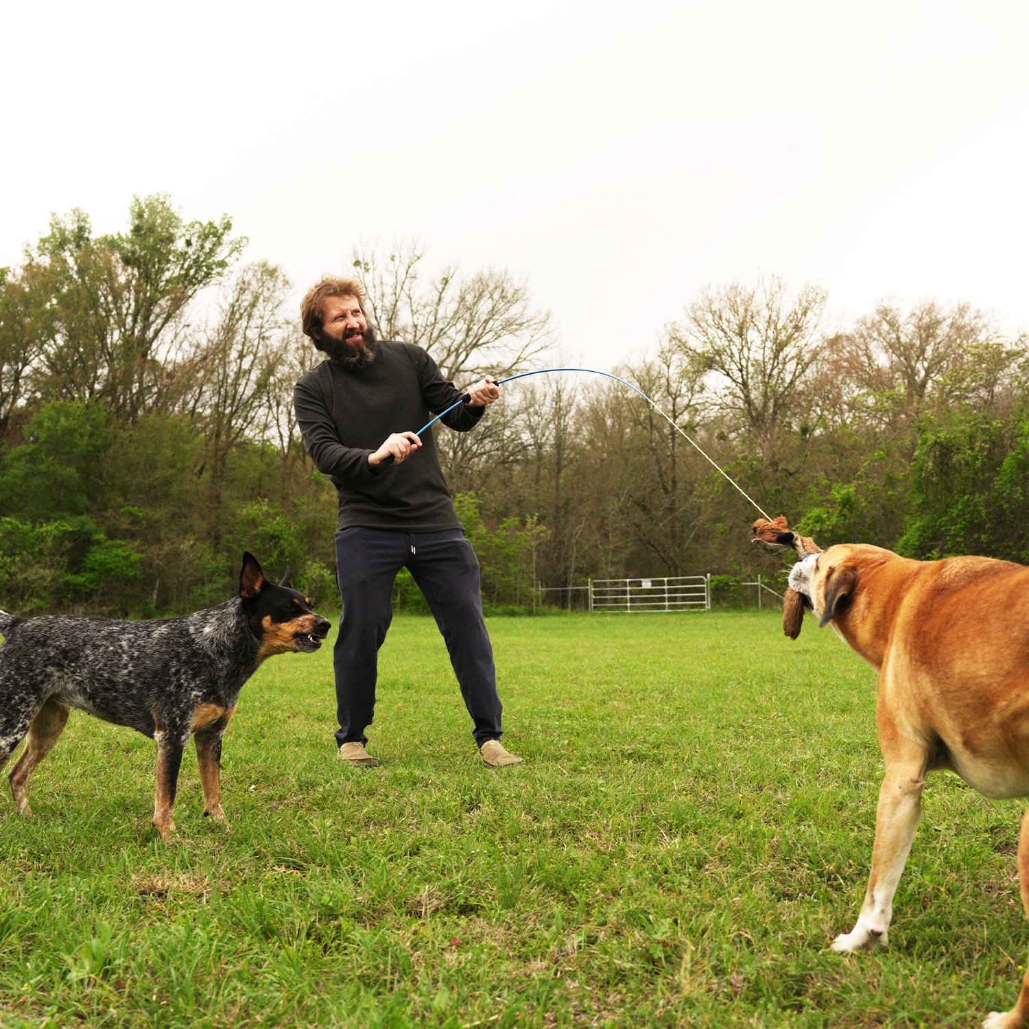Christopher Lee Moran using the Whimsy Stick to play with his dog Jax